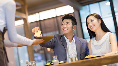 Couple paying for dinner in restaurant